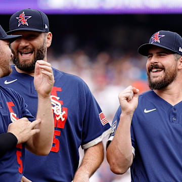 American League pitcher Carlos Rodon of the Chicago White Sox (right) laughs as he talks with pitcher Liam Hendriks of the Chicago White Sox (left) and pitcher Lance Lynn of the Chicago White Sox (center) before the 2021 MLB All Star Game at Coors Field on July 13, 2021.