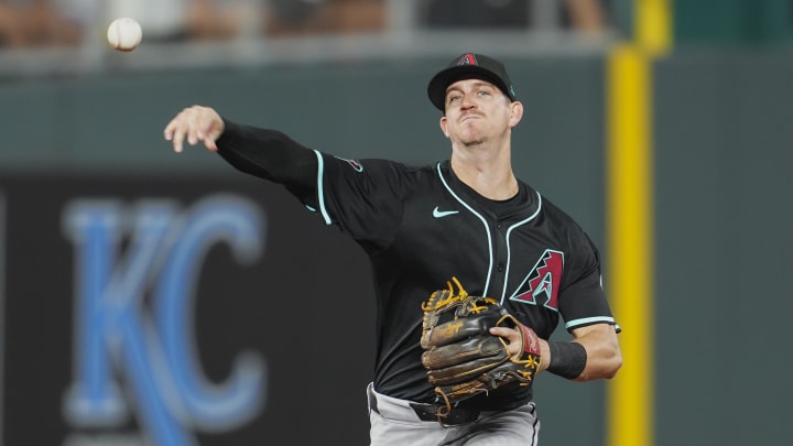 Jul 22, 2024; Kansas City, Missouri, USA; Arizona Diamondbacks shortstop Kevin Newman (18) throws to first base during the seventh inning against the Kansas City Royals at Kauffman Stadium. Mandatory Credit: Jay Biggerstaff-USA TODAY Sports