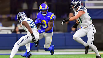 Dec 4, 2022; Inglewood, California, USA; Los Angeles Rams running back Cam Akers (3) runs the ball against Seattle Seahawks cornerback Mike Jackson (30) and defensive end L.J. Collier (91) during the first half at SoFi Stadium. Mandatory Credit: Gary A. Vasquez-Imagn Images