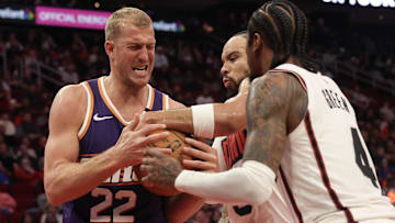 Feb 12, 2025; Houston, Texas, USA; Phoenix Suns center Mason Plumlee (22) and Houston Rockets forward Dillon Brooks (9) and  guard Jalen Green (4) fight over a rebound in the second quarter at Toyota Center. Mandatory Credit: Thomas Shea-Imagn Images