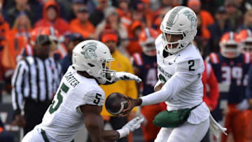 Nov 16, 2024; Champaign, Illinois, USA; Michigan State Spartans quarterback Aidan Chiles (2) hands the ball to running back Nate Carter (5) during the first half against the Illinois Fighting Illini at Memorial Stadium.