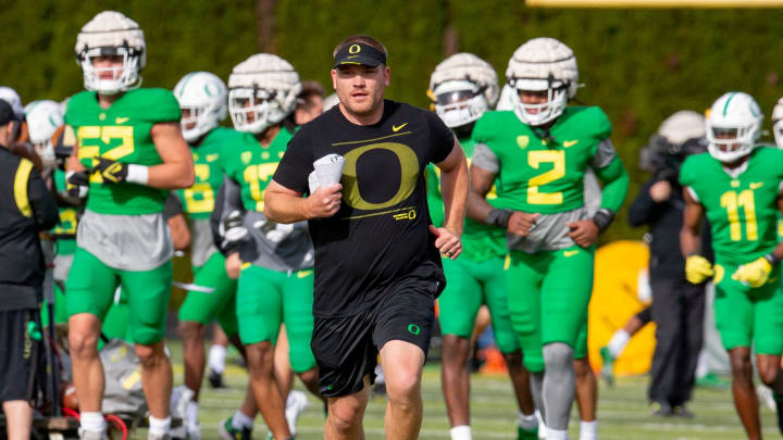 Oregon defensive coordinator Tosh Lupoi runs between drills during practice for the Ducks on Tuesday, April 5, 2022.

O40522 Eug Football Practice 3