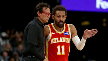 Oct 11, 2025; Memphis, Tennessee, USA; Atlanta Hawks head coach Quin Snyder (left) talks with Atlanta Hawks guard Trae Young (11) during the first quarter against the Memphis Grizzlies at FedExForum. Mandatory Credit: Petre Thomas-Imagn Images