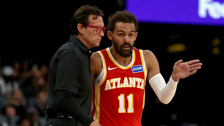 Oct 11, 2025; Memphis, Tennessee, USA; Atlanta Hawks head coach Quin Snyder (left) talks with Atlanta Hawks guard Trae Young (11) during the first quarter against the Memphis Grizzlies at FedExForum. Mandatory Credit: Petre Thomas-Imagn Images