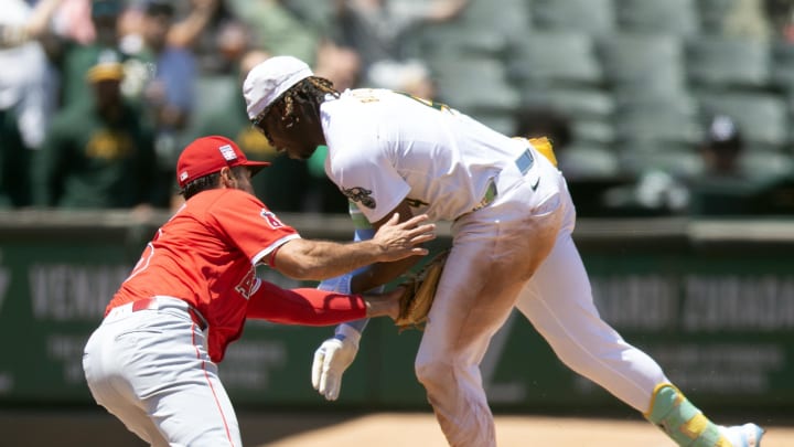 Jul 20, 2024; Oakland, California, USA; Los Angeles Angels third baseman Anthony Rendon (6) tags out Oakland Athletics right fielder Lawrence Butler (4) as he tries to stretch a double into a triple during the fourth inning at Oakland-Alameda County Coliseum. Mandatory Credit: D. Ross Cameron-USA TODAY Sports