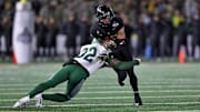 Army Black Knights running back runs with the ball and is met by Tulane Green Wave safety, Bailey Despanie. 
