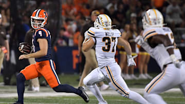 Sep 13, 2025; Champaign, Illinois, USA;  Illinois Fighting Illini quarterback Luke Altmyer (9) eludes Western Michigan Broncos linebacker Gabe Welch (37) on a run during the second half at Memorial Stadium. Mandatory Credit: Ron Johnson-Imagn Images