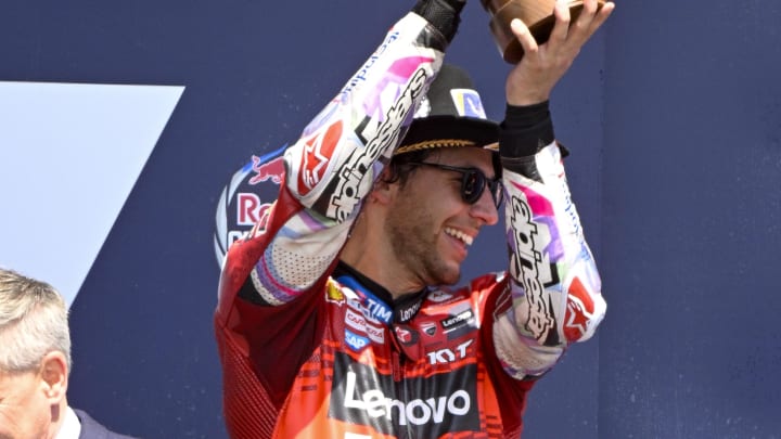 Apr 14, 2024; Austin, TX, USA; Enea Bastianini (23) of Italy and Ducati Lenovo Team raises his trophy on the podium after he finishes in third place in the MotoGP Grand Prix of The Americas at Circuit of The Americas. Mandatory Credit: Jerome Miron-USA TODAY Sports