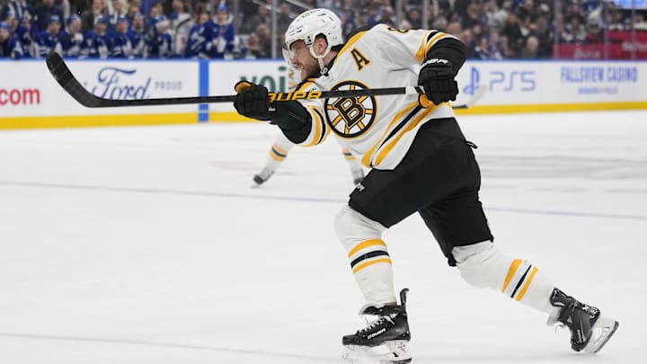 Jan 4, 2025; Toronto, Ontario, CAN; Boston Bruins forward David Pastrnak (88) shoots the puck against the Toronto Maple Leafs during the second period at Scotiabank Arena. Mandatory Credit: John E. Sokolowski-Imagn Images