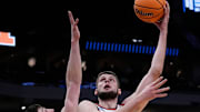 Xavier forward Zach Freemantle (32) attempts to block Illinois center Tomislav Ivisic (13) during the second half of their first round NCAA men’ s basketball tournament game on Friday March 21, 2025 at Fiserv Forum in Milwaukee, Wis.