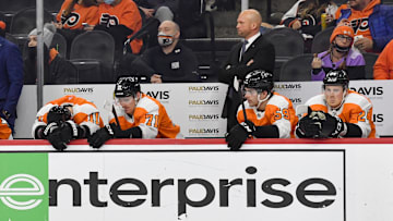 Jan 24, 2022; Philadelphia, Pennsylvania, USA; Philadelphia Flyers interim head coach Mike Yeo, right, stands behind his team as time runs out in a loss to the Dallas Stars during the third period at Wells Fargo Center.