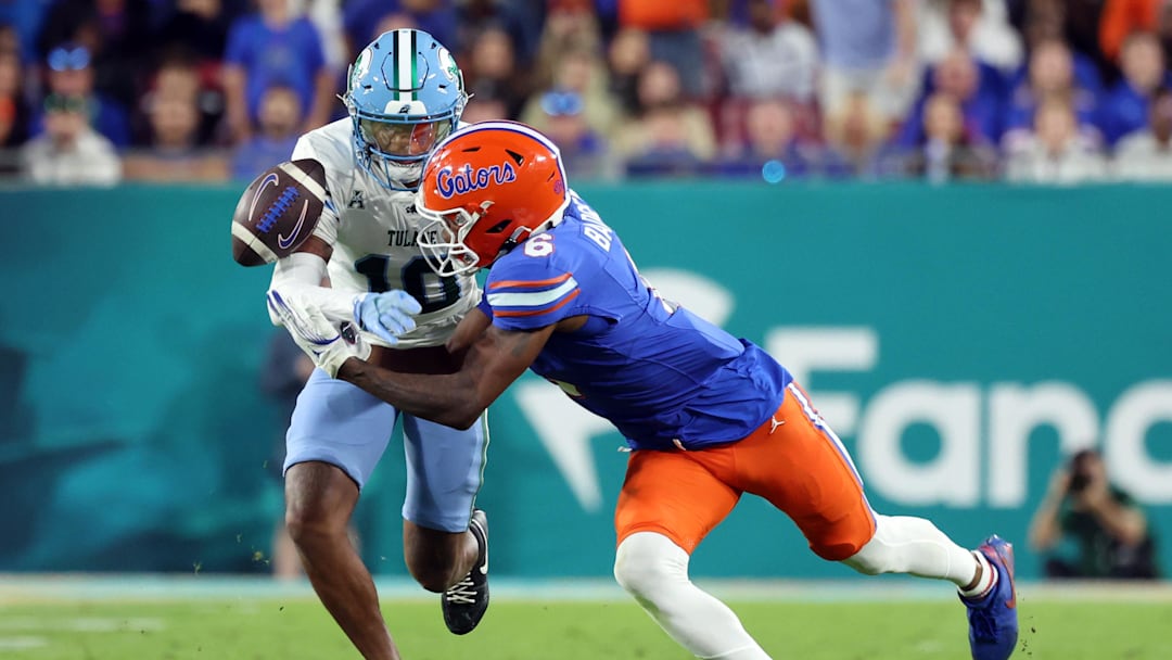 Dec 20, 2024; Tampa, FL, USA; Tulane Green Wave defensive back Lu Tillery (10) breaks up Florida Gators wide receiver Elijhah Badger (6) catch during the second half at Raymond James Stadium. 