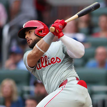 Jul 5, 2024; Atlanta, Georgia, USA; Philadelphia Phillies catcher Rafael Marchan (13) hits a single against the Atlanta Braves in the second inning at Truist Park.