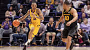 Mar 9, 2024; Baton Rouge, Louisiana, USA; LSU Tigers forward Tyrell Ward (15) brings the ball up court against Missouri Tigers guard Nick Honor (10) during the first half at Pete Maravich Assembly Center. Mandatory Credit: Stephen Lew-Imagn Images