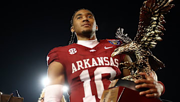 Dec 27, 2024; Memphis, TN, USA; Arkansas Razorbacks quarterback Taylen Green (10) holds the AutoZone Liberty Bowl MVP trophy after defeating against the Texas Tech Red Raiders at Simmons Bank Liberty Stadium. Mandatory Credit: Petre Thomas-Imagn Images