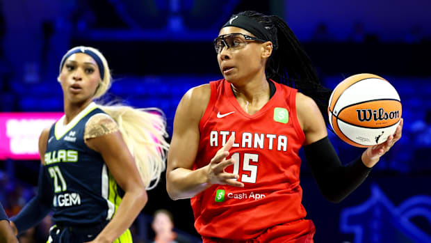 A photo of Allisha Gray driving to the hoop