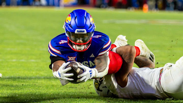 Nov 23, 2024; Kansas City, Missouri, USA;  Kansas running back Devin Neal (4) dives into the end zone during the 3rd  quarter between the Kansas Jayhawks and the Colorado Buffaloes at GEHA Field at Arrowhead Stadium. Mandatory Credit: Nick Tre. Smith-Imagn Images