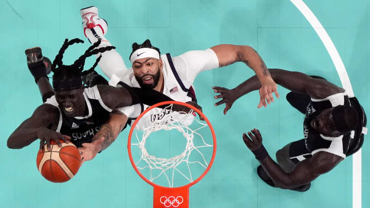 Jul 31, 2024; Villeneuve-d'Ascq, France; United States center Anthony Davis (14) fights with South Sudan power forward Wenyen Gabriel (9) and point guard Marial Shayok (11) for a rebound in the third quarter during the Paris 2024 Olympic Summer Games at Stade Pierre-Mauroy. Mandatory Credit: John David Mercer-USA TODAY Sports