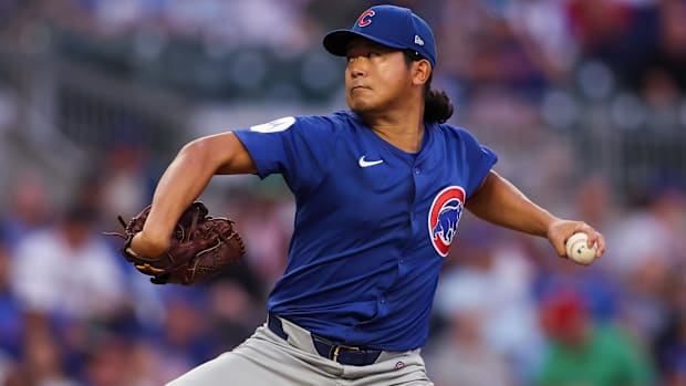 Imanaga getting ready to throw a ball in his start in a blue jersey with blue ha