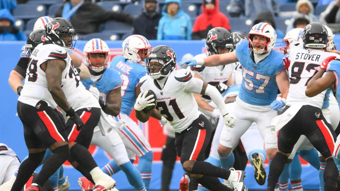 Jan 5, 2025; Nashville, Tennessee, USA;  Houston Texans running back Dameon Pierce (31) runs the ball against the Tennessee Titans during the first half at Nissan Stadium. Mandatory Credit: Steve Roberts-Imagn Images