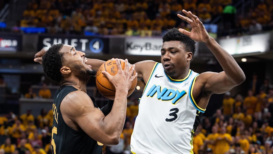 May 9, 2025; Indianapolis, Indiana, USA; Cleveland Cavaliers guard Donovan Mitchell (45) shoots the ball while  Indiana Pacers center Thomas Bryant (3) defends during game three of the second round for the 2025 NBA Playoffs at Gainbridge Fieldhouse. Mandatory Credit: Trevor Ruszkowski-Imagn Images