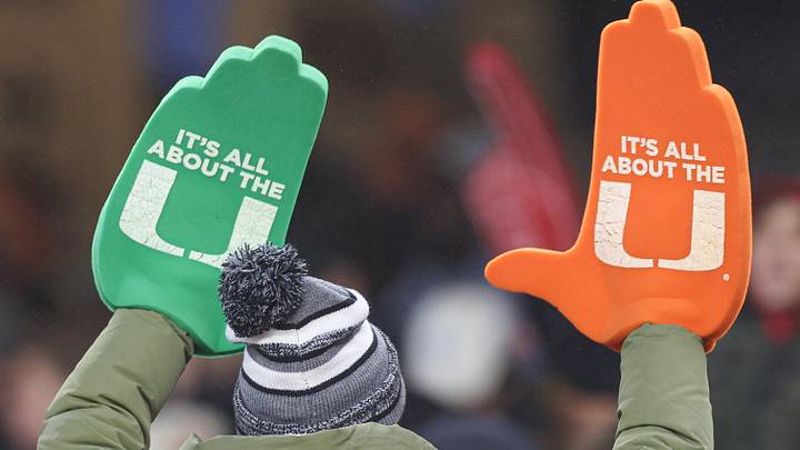Dec 28, 2023; Bronx, NY, USA; A Miami Hurricanes fan holds up foam hands during the second half of the 2023 Pinstripe Bowl against the Rutgers Scarlet Knights at Yankee Stadium. Mandatory Credit: Vincent Carchietta-USA TODAY Sports