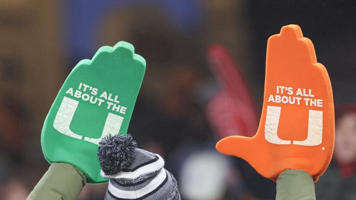 Dec 28, 2023; Bronx, NY, USA; A Miami Hurricanes fan holds up foam hands during the second half of the 2023 Pinstripe Bowl against the Rutgers Scarlet Knights at Yankee Stadium. Mandatory Credit: Vincent Carchietta-USA TODAY Sports