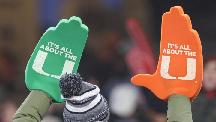 Dec 28, 2023; Bronx, NY, USA; A Miami Hurricanes fan holds up foam hands during the second half of the 2023 Pinstripe Bowl against the Rutgers Scarlet Knights at Yankee Stadium. Mandatory Credit: Vincent Carchietta-USA TODAY Sports