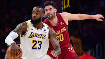 Apr 6, 2024; Los Angeles, California, USA; Los Angeles Lakers forward LeBron James (23) moves the ball ahead of Cleveland Cavaliers forward Georges Niang (20) during the first half at Crypto.com Arena. Mandatory Credit: Gary A. Vasquez-Imagn Images