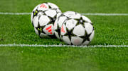 Four Adidas official balls are seen on the pitch during the...
