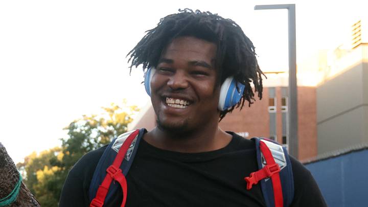 Nov 15, 2025; Oxford, Mississippi, USA; Mississippi Rebels defensive lineman Zxavian Harris (51) carries an alligator from a fan as he makes his way down the Walk of Champions to Vaught-Hemingway Stadium prior to the game against the Florida Gators.  Mandatory Credit: Petre Thomas-Imagn Images