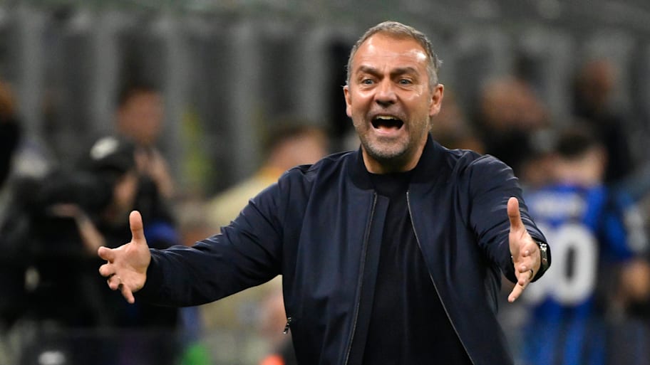 Hansi Flick with arms outstretched.