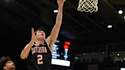 Feb 27, 2024; Dayton, Ohio, USA;  Davidson forward Bobby Durkin (2) shoots the ball against Dayton Flyers forward Nate Santos (2) during the first half of the game at University of Dayton Arena. Mandatory Credit: Matt Lunsford-Imagn Images