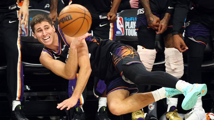 Phoenix Suns guard Collin Gillespie dives to try and save the ball from going out of bounds against the Portland Trail Blazers in the second half during the play-in rounds of the 2026 NBA Playoffs at Mortgage Matchup Center.