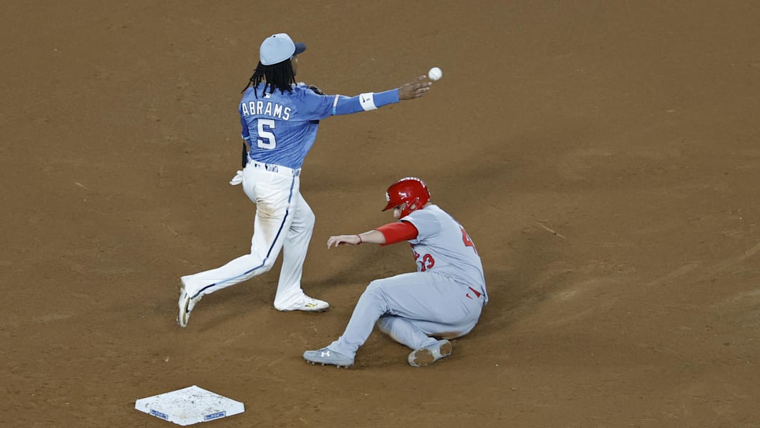 May 9, 2025; Washington, District of Columbia, USA; Washington Nationals shortstop CJ Abrams (5) makes a throwing error while attempting to turn a double play at second base ahead of a slide by St. Louis Cardinals catcher Pedro Pagés (43) during the ninth inning at Nationals Park. Mandatory Credit: Geoff Burke-Imagn Images