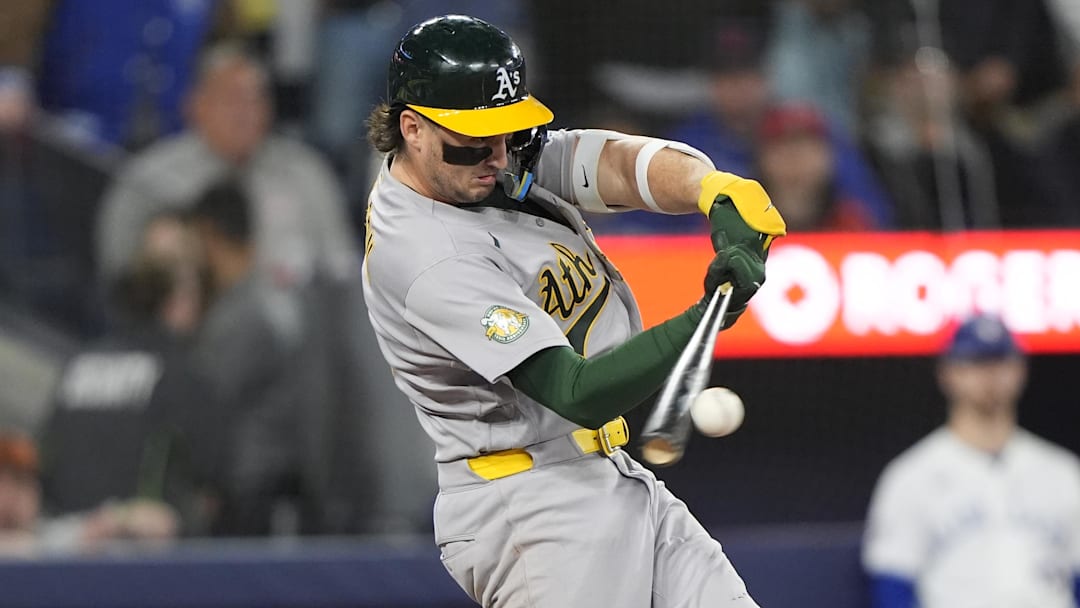 Mar 29, 2026; Toronto, Ontario, CAN; Athletics shortstop Jacob Wilson (5) hits a single against the Toronto Blue Jays during the ninth inning at Rogers Centre. Mandatory Credit: John E. Sokolowski-Imagn Images