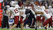 Sep 20, 2025; Charlottesville, Virginia, USA; Stanford Cardinal quarterback Ben Gulbranson (15) throws a sixty yard pass to Cardinal wide receiver Bryce Farrell (not pictured) as Virginia Cavaliers defensive end Mitchell Melton (17) defends during the first quarter at Scott Stadium. Mandatory Credit: Geoff Burke-Imagn Images