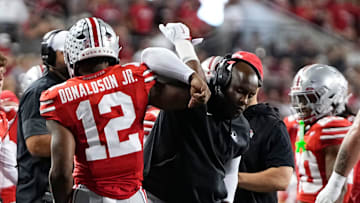 Ohio State Buckeyes running back CJ Donaldson Jr. (12) celebrates a touchdown with running backs coach Carlos Locklyn during the NCAA football game at Ohio Stadium in Columbus on Oct. 4, 2025.