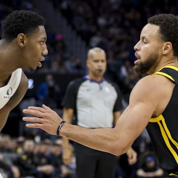 Golden State Warriors guard Stephen Curry (30) defends against Toronto Raptors forward RJ Barrett (9) during the second half at Chase Center. Mandatory Credit: John Hefti-Imagn Images