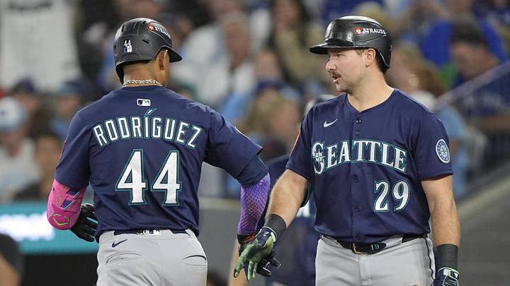 Oct 20, 2025; Toronto, Ontario, CAN; Seattle Mariners center fielder Julio Rodriguez (44) celebrates with catcher Cal Raleigh (29) after hitting a solo home run against the Toronto Blue Jays in the third inning during game seven of the ALCS round for the 2025 MLB playoffs at Rogers Centre. Mandatory Credit: John E. Sokolowski-Imagn Images