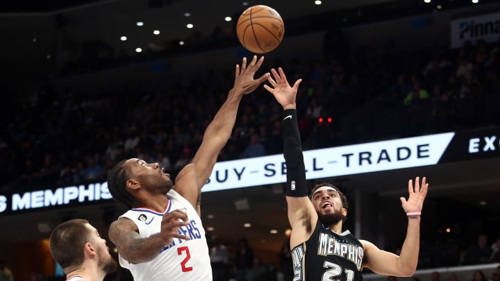 Mar 31, 2023; Memphis, Tennessee, USA; Memphis Grizzlies guard Tyus Jones (21) shoots as Los Angeles Clippers forward Kawhi Leonard (2) defends during the first half at FedExForum. Mandatory Credit: Petre Thomas-USA TODAY Sports