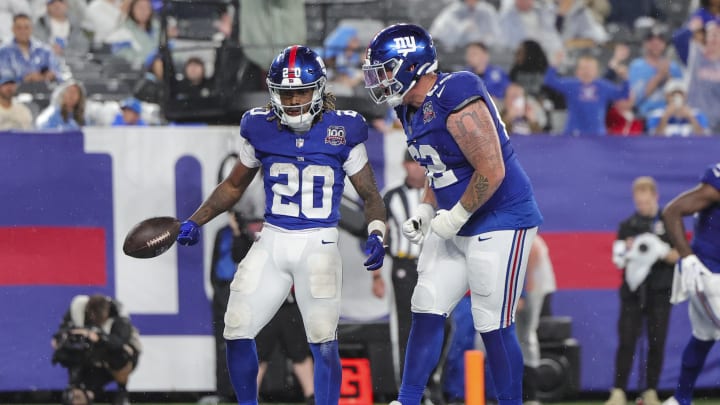 Aug 8, 2024; East Rutherford, New Jersey, USA;  New York Giants running back Eric Gray (20) celebrates a touchdown with New York Giants guard Jalen Mayfield (62) during the preseason game against the Detroit Lions  at MetLife Stadium.  