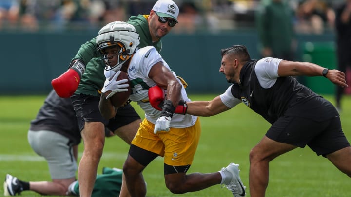 Gren Bay Packers running back MarShawn Lloyd (32) runs through a ball-security drill at training camp on Aug. 6.