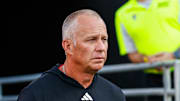Aug 28, 2025; Raleigh, North Carolina, USA; North Carolina State Wolfpack head coach Dave Doeren walks out during the warmups prior to the game against East Carolina Pirates at Carter-Finley Stadium. Mandatory Credit: Jaylynn Nash-Imagn Images