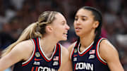 Apr 6, 2025; Tampa, FL, USA; Connecticut Huskies guard Paige Bueckers (5) reacts with teammates guard Ashlynn Shade (12) and guard Azzi Fudd (35) during the second half against the South Carolina Gamecocks of the national championship of the women's 2025 NCAA tournament at Amalie Arena. Mandatory Credit: Nathan Ray Seebeck-Imagn Images
