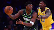 Apr 30, 2025; Los Angeles, California, USA; Minnesota Timberwolves guard Anthony Edwards (5) controls the ball against Los Angeles Lakers forward Dorian Finney-Smith (17) during the first half in game five of first round for the 2025 NBA Playoffs at Crypto.com Arena. Mandatory Credit: Gary A. Vasquez-Imagn Images
