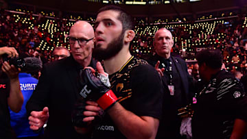Jan 18, 2025; Inglewood, California, USA; Islam Makhachev (red gloves) leaves the octagon after defeating Renato Moicano (not pictured) in a lightweight title fight during UFC 311 at Intuit Dome. Mandatory Credit: Gary A. Vasquez-Imagn Images