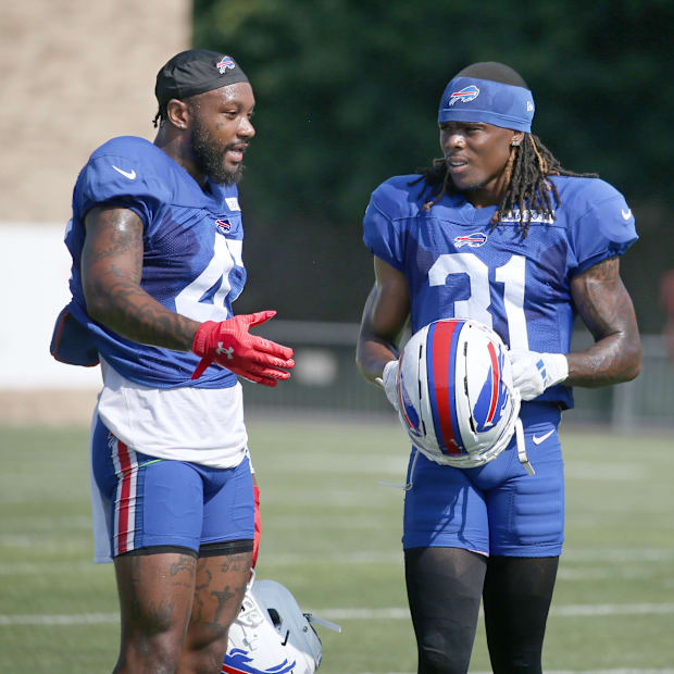 Christian Benford talks with rookie Maxwell Hairston between drills