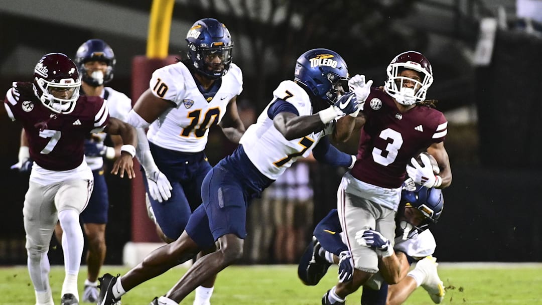 Sep 14, 2024; Starkville, Mississippi, USA; Mississippi State Bulldogs wide receiver Kevin Coleman Jr. (3) is tackled by Toledo Rockets safety Emmanuel McNeil-Warren (7) and Toledo Rockets safety Maxen Hook (25) during the second quarter at Davis Wade Stadium at Scott Field. Mandatory Credit: Matt Bush-Imagn Images