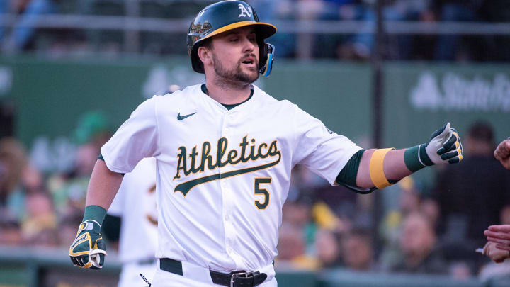 May 21, 2024; Oakland, California, USA; Oakland Athletics designated hitter J.D. Davis (5) celebrates with team mates after hitting a home run during the third inning against the Colorado Rockies at Oakland-Alameda County Coliseum. Mandatory Credit: Ed Szczepanski-USA TODAY Sports